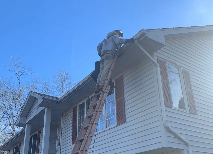 Gutter cleaning and maintenance being performed by South Euclid Power Washing in South Euclid